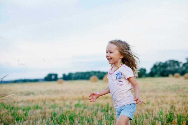 Image of a child running whilst caravanning with kids.