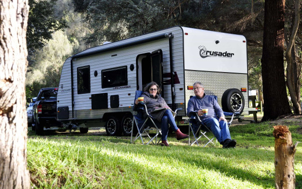 A couple pictured alongside their Crusader caravan