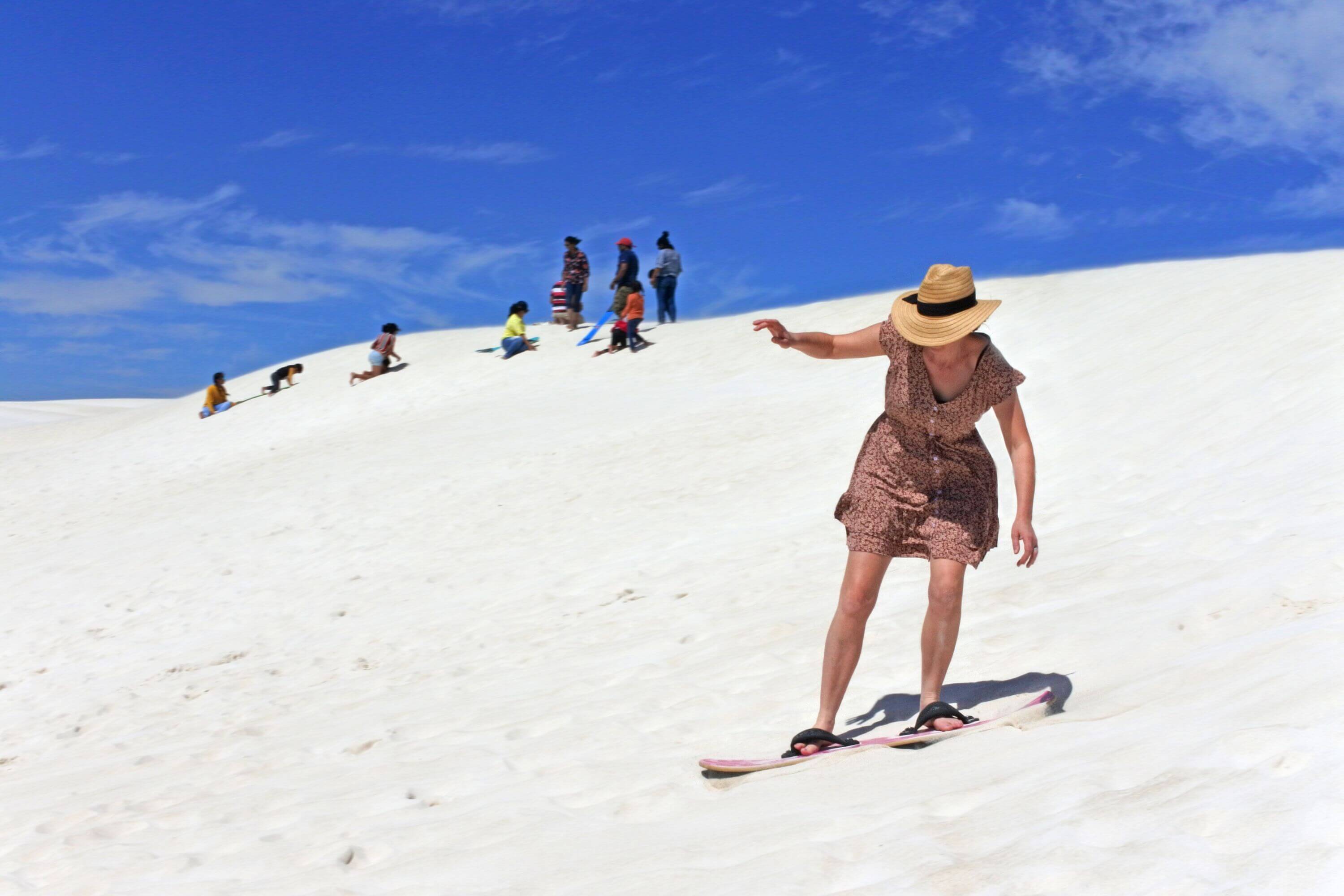 a person sandboarding in Lancelin sand dunes